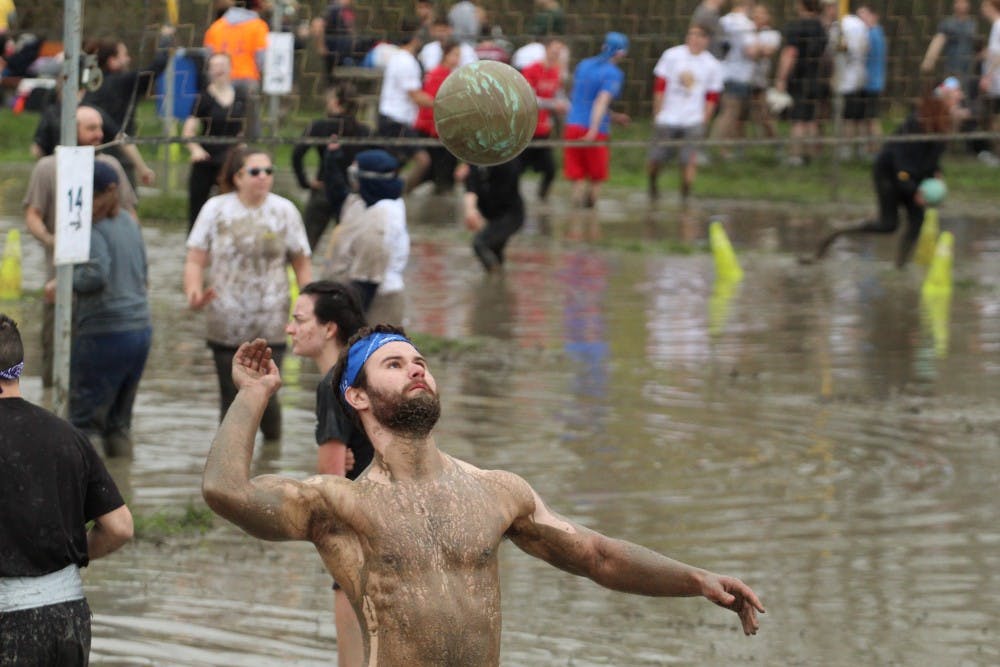 Oozefest participant gets ready to volley the ball. The further team members competed, the muddier they left the annual event.