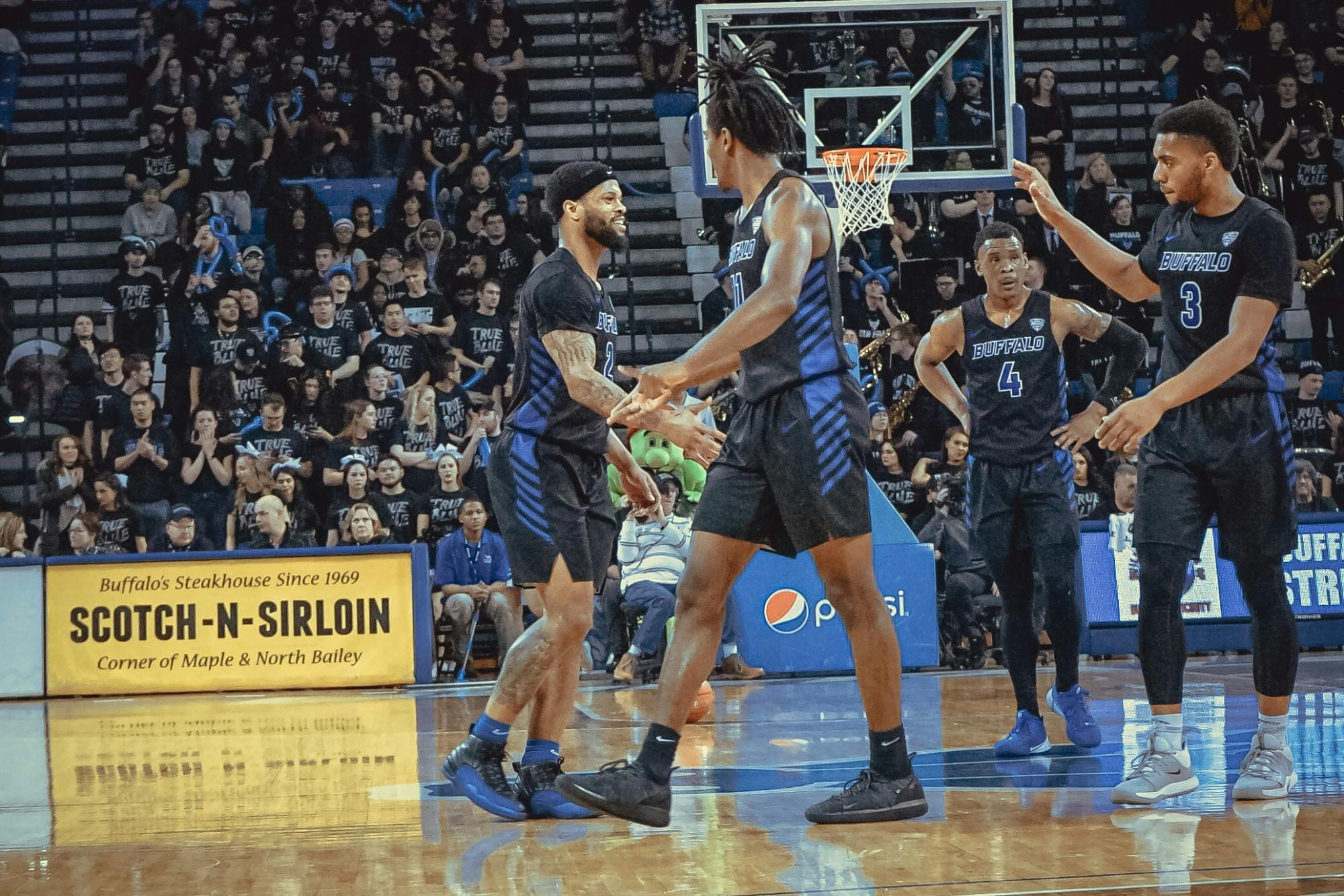 Men's basketball stands on the court at Alumni during a game last season.&nbsp;