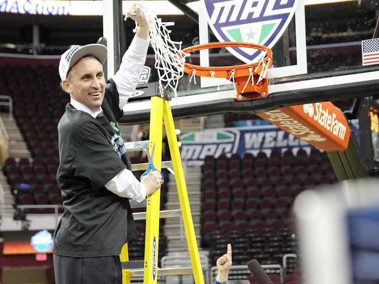 Head coach Bobby Hurley cuts down the net after Buffalo's 89-84 MAC championship win over Central Michigan Saturday. The Bulls will play No. 18 West Virginia in the NCAA Tournament on Friday. 