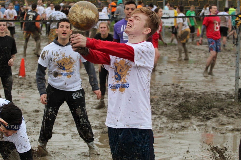 <p>UB student receives "back-splash" from a muddy volleyball. Many students left Oozefest with muddy faces from similar experiences.</p>