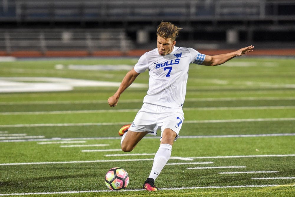 <p>Senior forward&nbsp;Russell Cicerone strikes a free kick at UB Stadium on Sept. 21. His goal and assist helped the men’s soccer team defeat St. Bonaventure 2-1.</p>