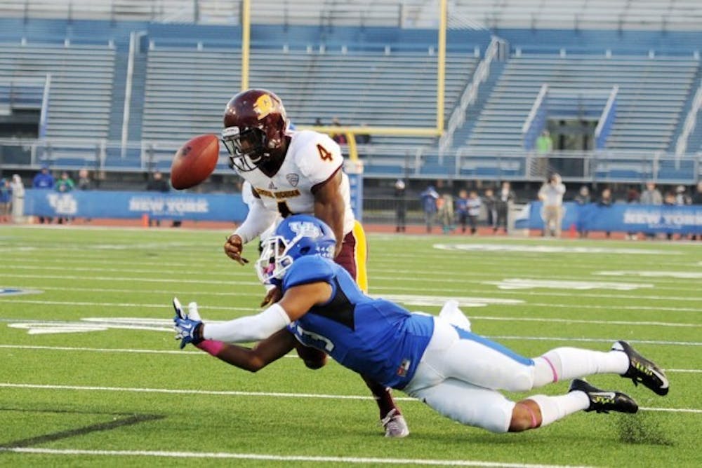 Senior wide receiver Devon Hughes dives for junior quarterback Joe Licata&rsquo;s pass during Buffalo&#39;s game against Central Michigan Saturday. Licata was picked off at the 2-yard line by Central Michigan&rsquo;s Brandon Greer.&nbsp;Yusong Shi, The Spectrum