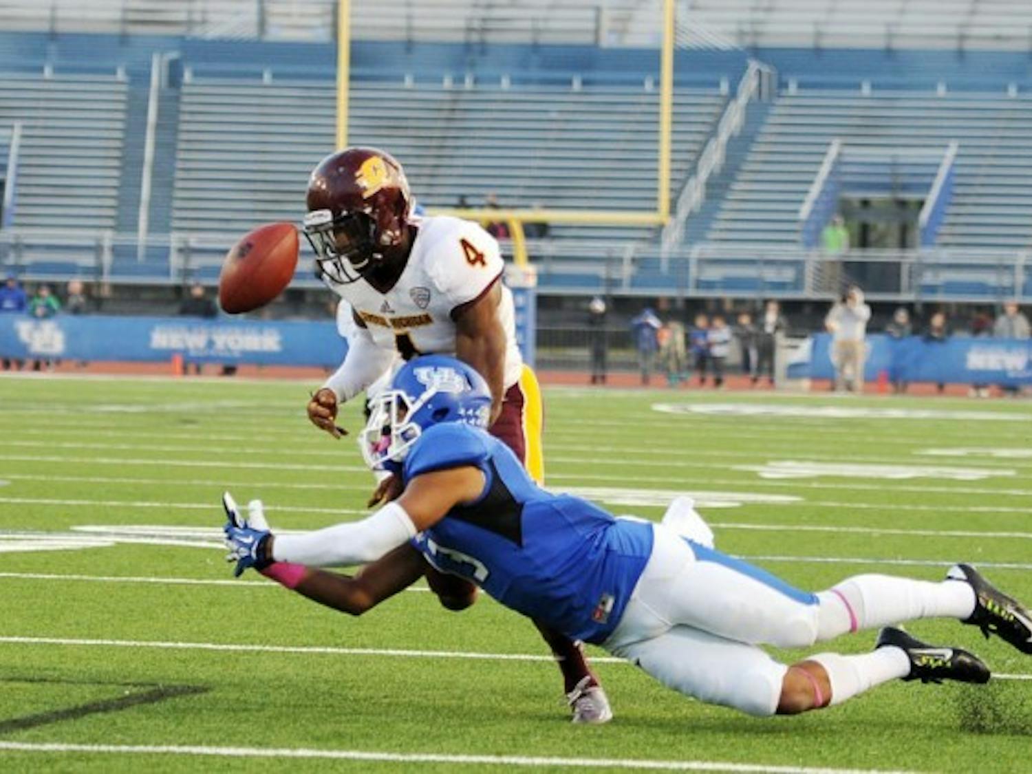 Senior wide receiver Devon Hughes dives for junior quarterback Joe Licata&rsquo;s pass during Buffalo&#39;s game against Central Michigan Saturday. Licata was picked off at the 2-yard line by Central Michigan&rsquo;s Brandon Greer.&nbsp;Yusong Shi, The Spectrum