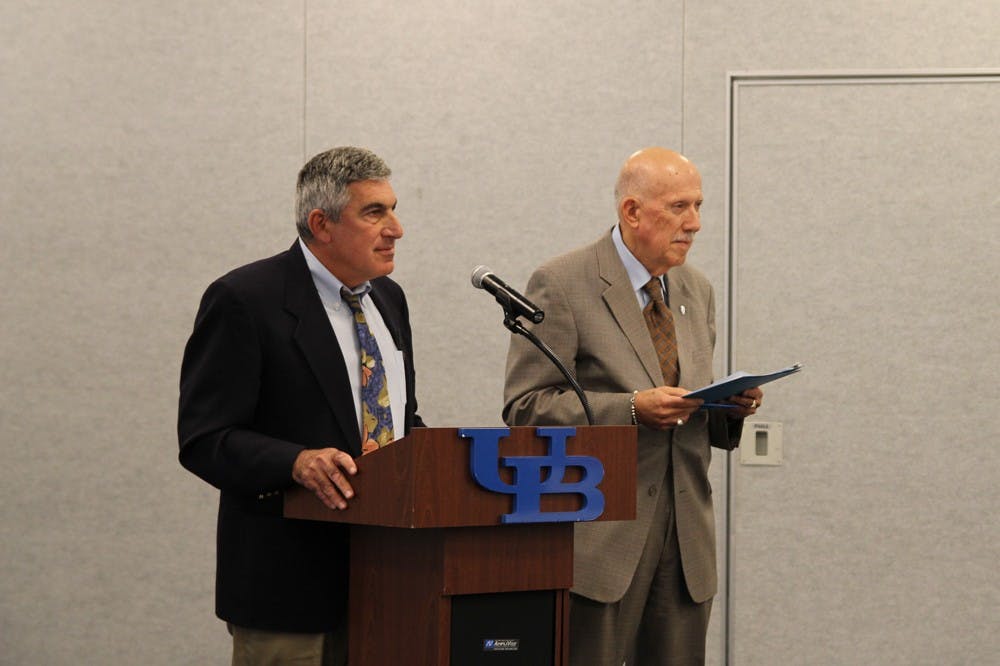 <p>Michael Chaskes, a professor in the Department of Medicine and Faculty Senate Chair Ezra Zubrow speak at Tuesday's Faculty Senate meeting. The Senate was unable to vote on new self-published textbook regulations because it did not have quorum.</p>