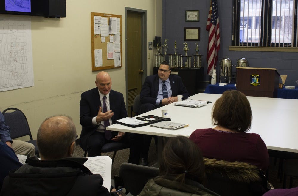 <p>Chris Bartolomei, interim chief of police (left) and Mark Coldren, chair of the chief of police search committee (right) talk during a community forum Wednesday. Bartolomei is one of three candidates being considered for the position. The other two candidates will speak at forums on Thursday and Friday.&nbsp;</p>