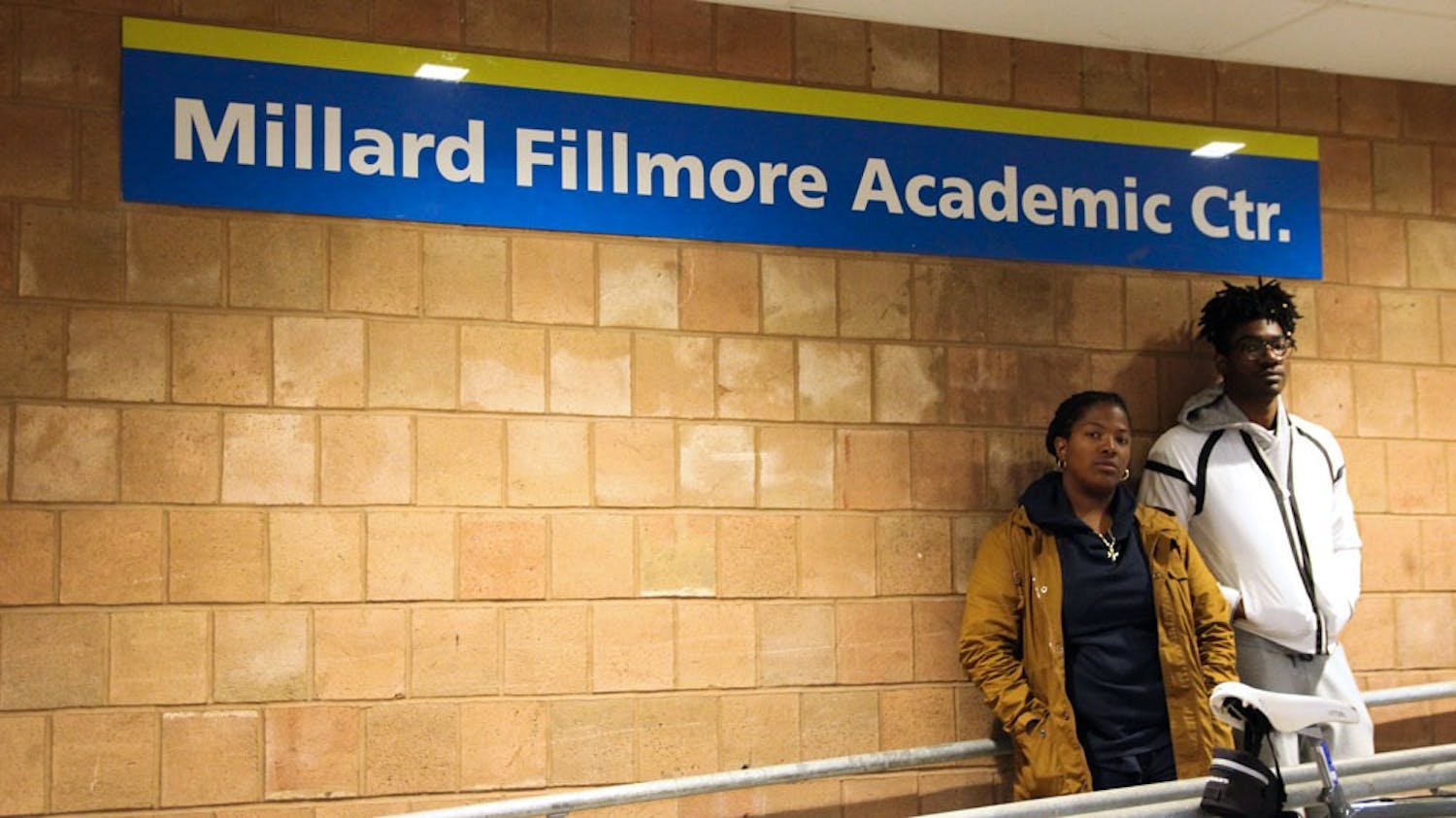 Deidree Golbourne (left) and Tavaine Whyte (right) stand outside of the Millard Fillmore Academic Center. The two question how UB represents Fillmore on campus and say more needs to be done to educate students of his history.