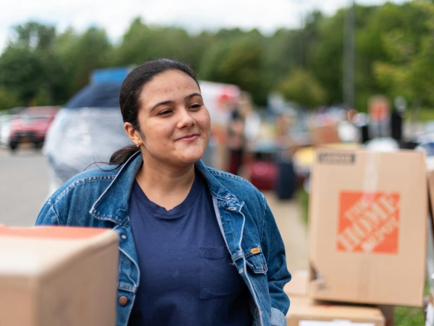 Sophomore Daphne Da Silva amongst piles of boxes.