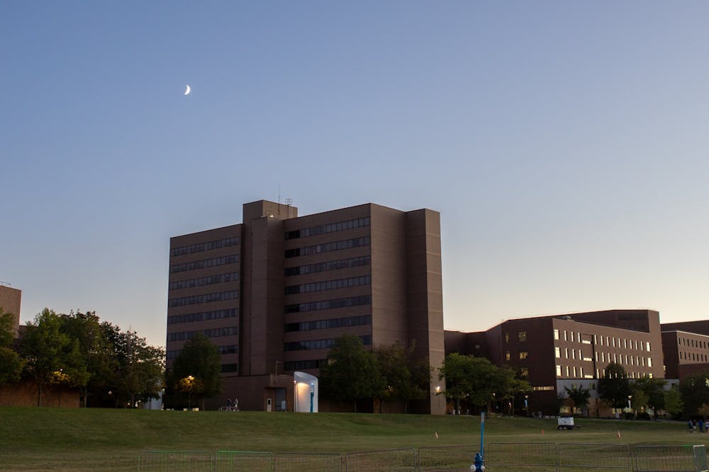 The sun sets behind Clemens Hall.
