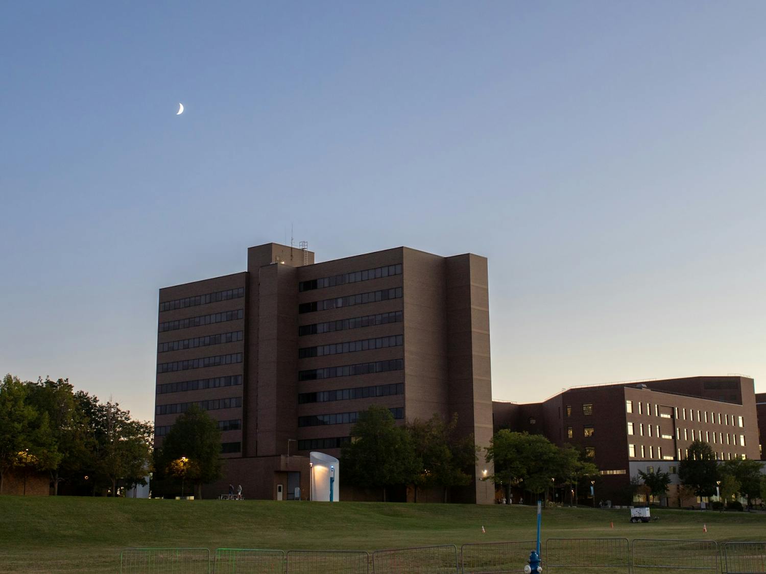 The sun sets behind Clemens Hall.