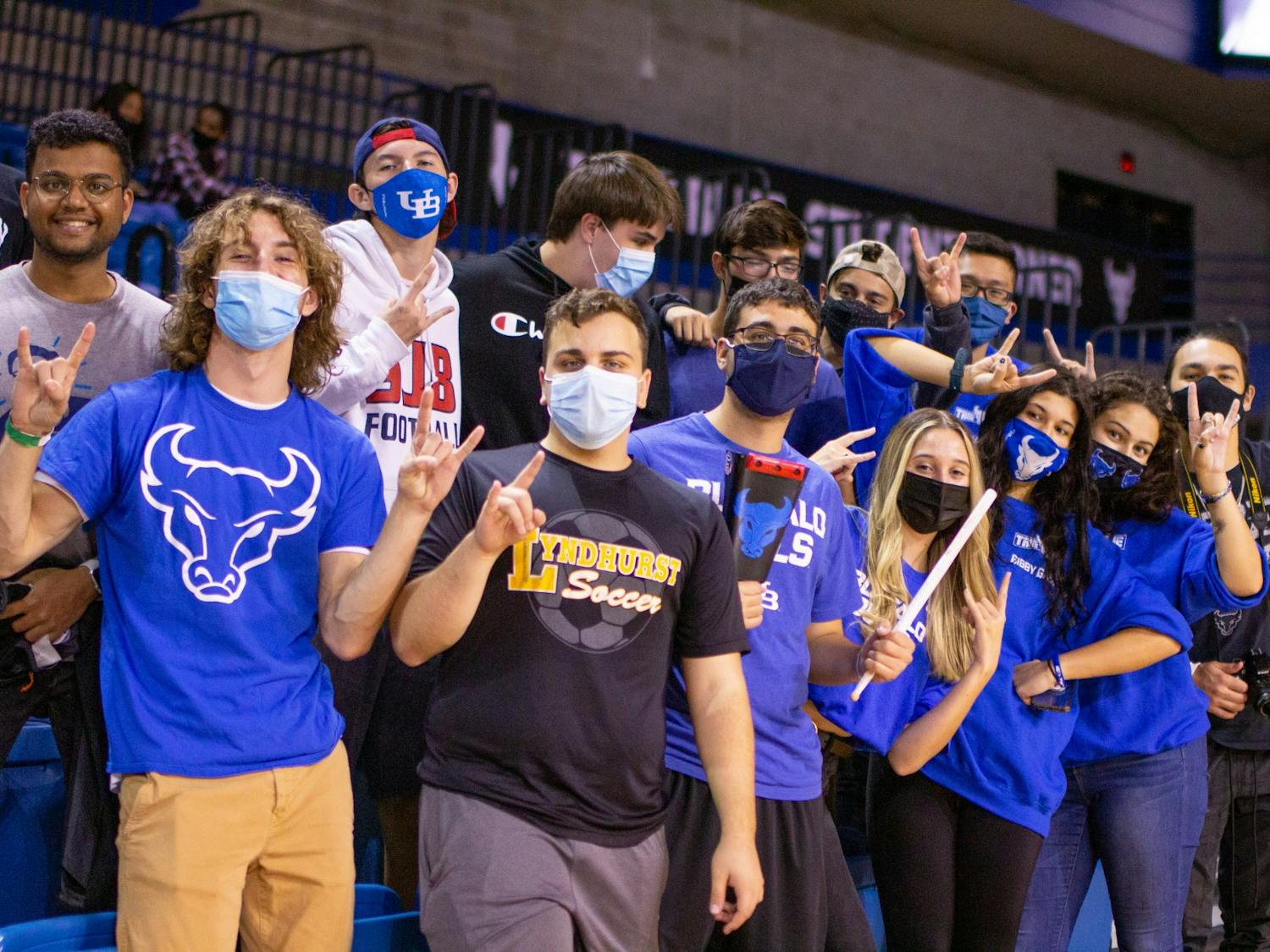 Fans pose for a photo at a women's volleyball game at Alumni Arena last semester.