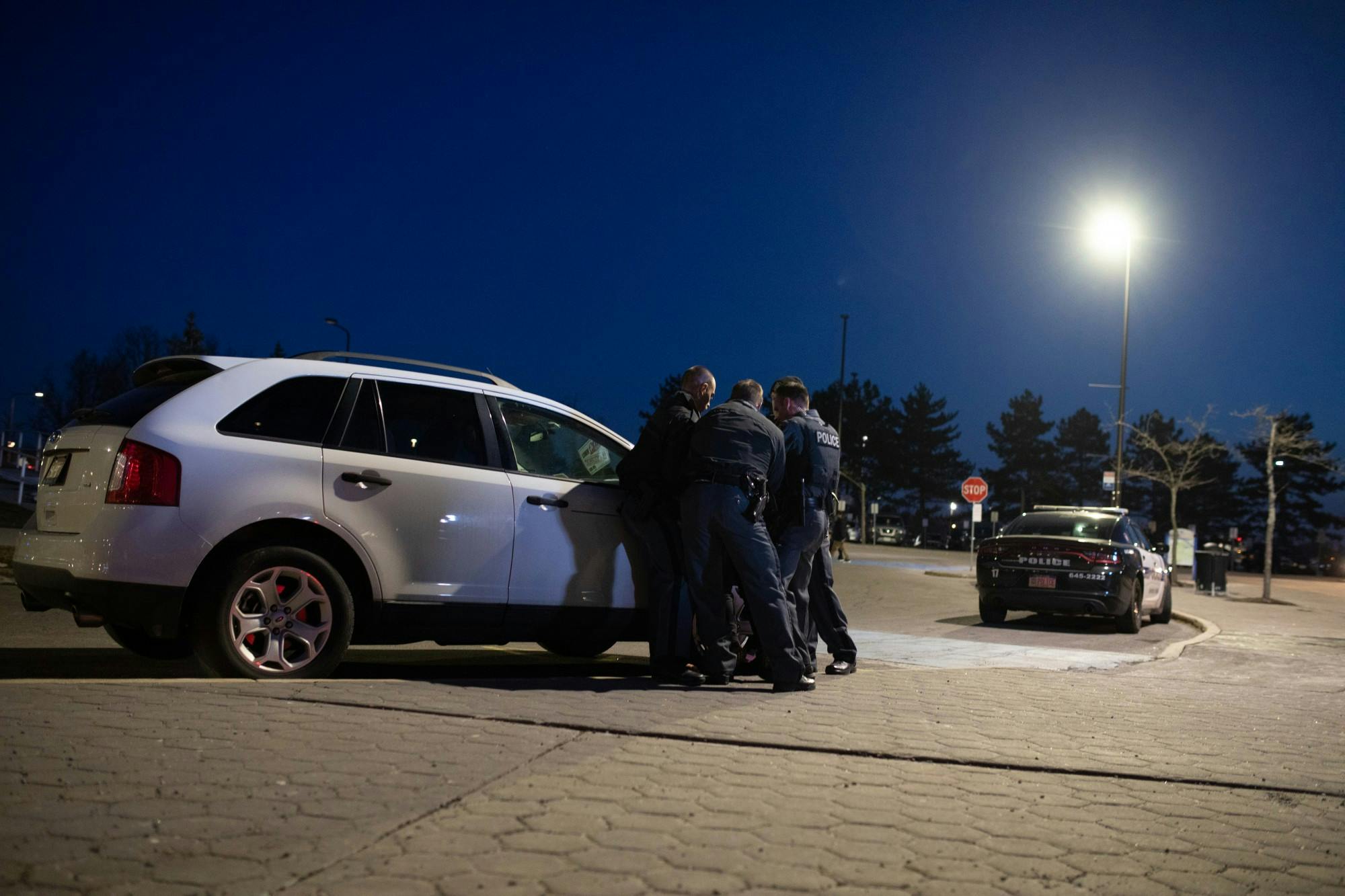 Four officers grabbed the protester, pushed them against a nearby parked car, put them in handcuffs and placed them under arrest.&nbsp;&nbsp;