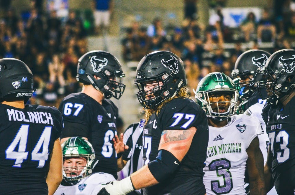 <p>Senior center James O’Hagan stands tall after a play. The tattoo on his left shoulder is a bald eagle in front of a waving American Flag. The tattoo represents his love for the country and American values.</p>