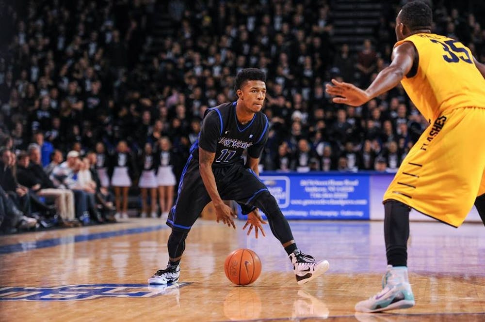 <p>Shannon Evans dribbles the ball in between his legs during Buffalo's 80-55 win over Kent State on Jan. 30. Evans scored 21 points Saturday night to help the Bulls defeat Kent State again, this time for a second place tie with the Golden Flashes in the MAC East. </p>