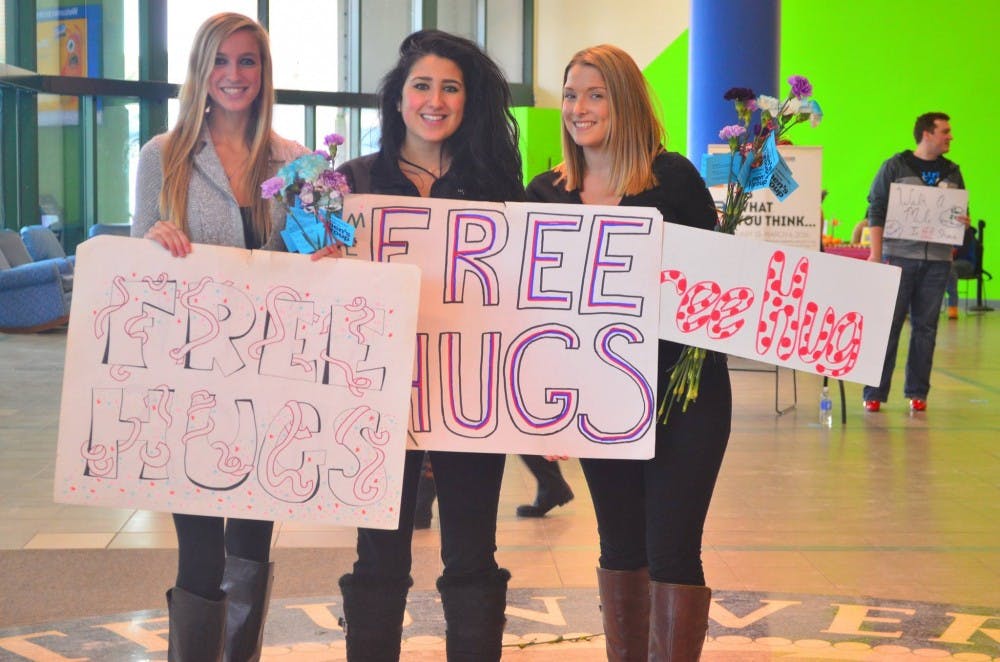 <p>Students Taylor Williams, Kadriye Tekin and&nbsp;Alexis Antoniou&nbsp;participate in Love and Support Day in the Student Union Thursday&nbsp;by giving away free hugs. The annual event aims to teach&nbsp;students about self-love and self-worth.&nbsp;</p>