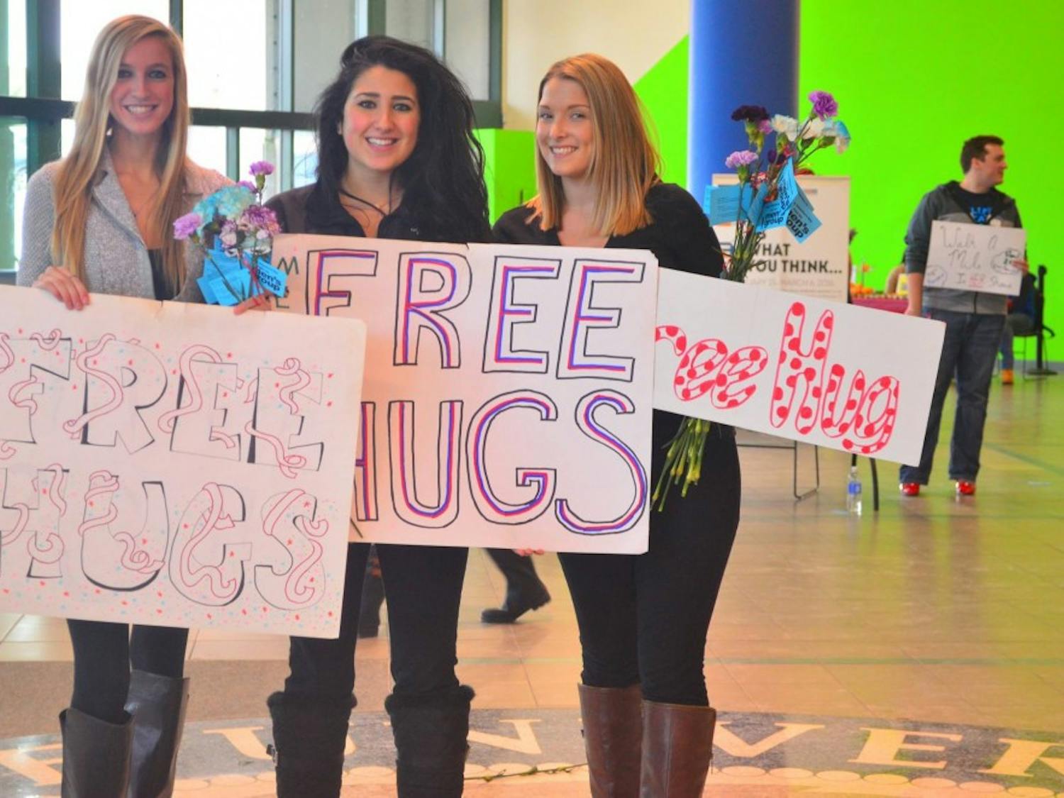Students Taylor Williams, Kadriye Tekin and&nbsp;Alexis Antoniou&nbsp;participate in Love and Support Day in the Student Union Thursday&nbsp;by giving away free hugs. The annual event aims to teach&nbsp;students about self-love and self-worth.&nbsp;