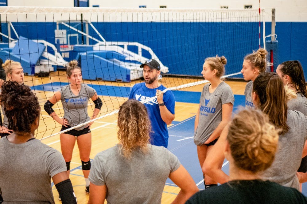 <p>Coach Smith instructing the volleyball team during a practice at Alumni Arena.</p>