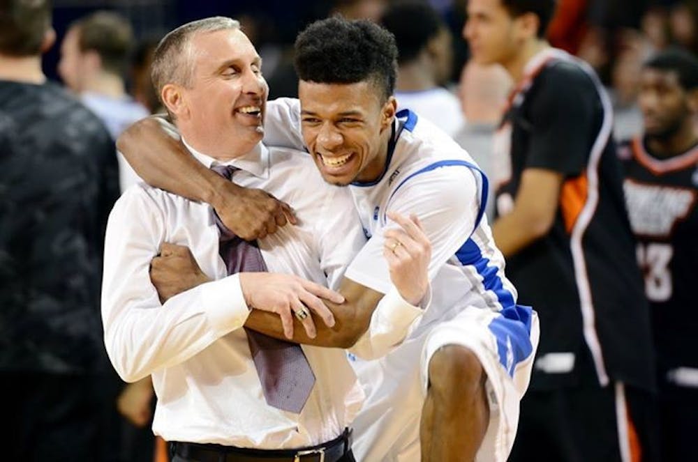 <p>Shannon Evans and former head coach Bobby Hurley embrace after Buffalo's 77-75 win over Bowling Green in Alumni Arena on March 6. Evans announced on Friday that he will be transferring to Arizona State.</p>