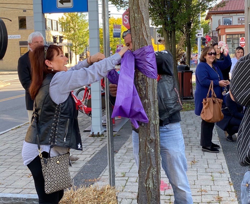 <p>Buffalo community members tied purple ribbons to show resilience for domestic abuse survivors.</p>