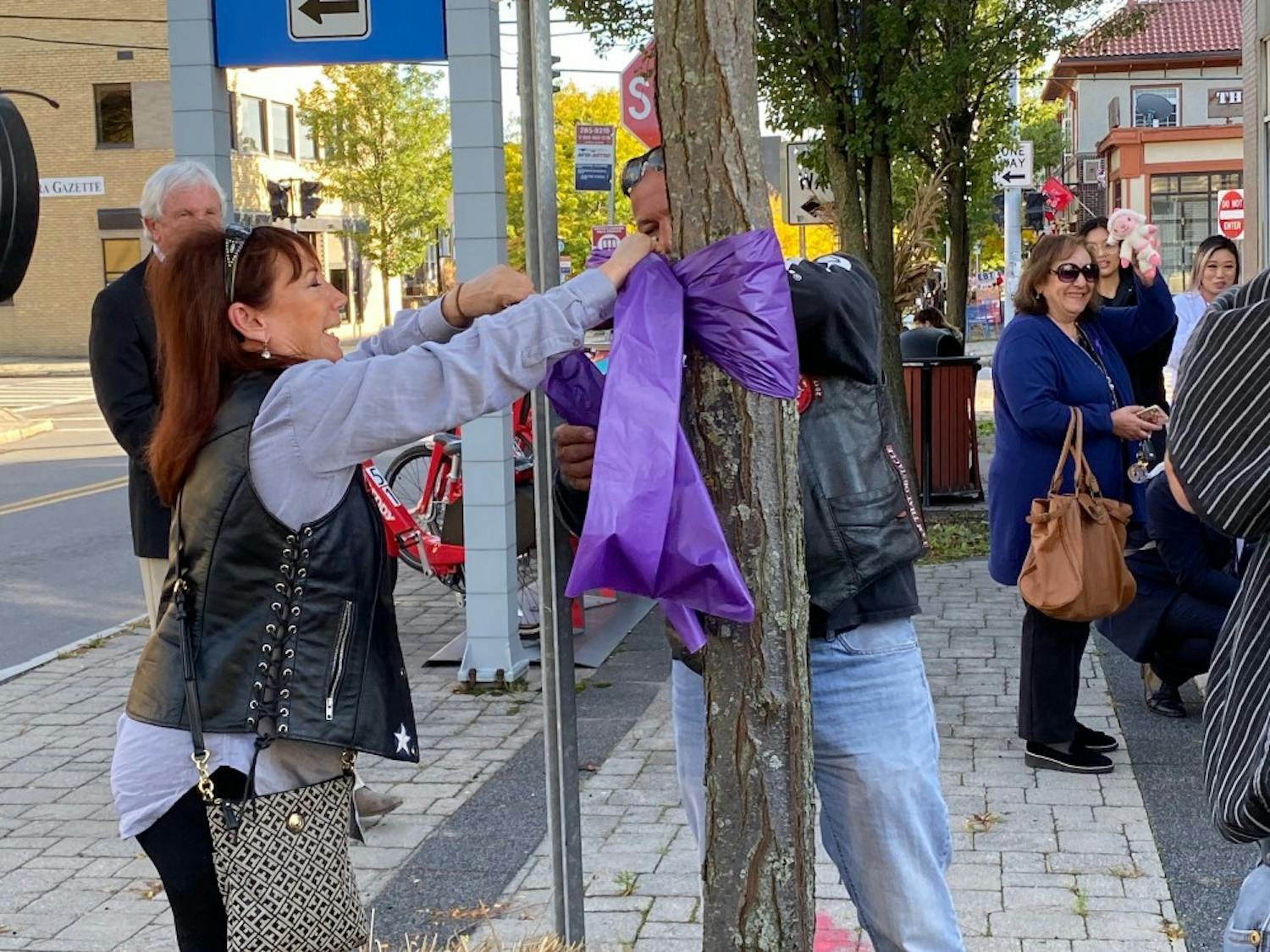 Buffalo community members tied purple ribbons to show resilience for domestic abuse survivors.