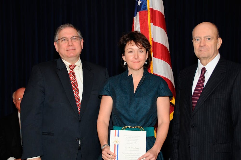 <p>Lawrence Tabak (left) and Amy Heimberger (middle) pose for a photo in 2007.</p>