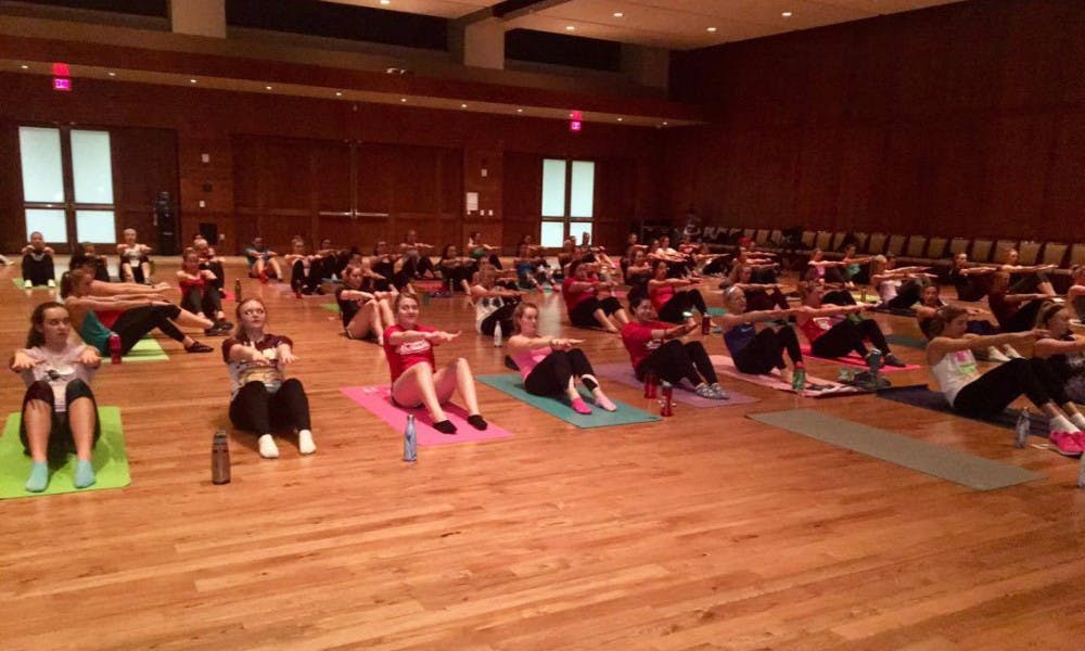 Members of the all-woman lifestyle student organization Changing Health, Attitudes, Actions to Recreate Girls at UW-Madison workout during a weekly session, which are either taught by a member of the group’s executive staff or an instruction from a local fitness studio.