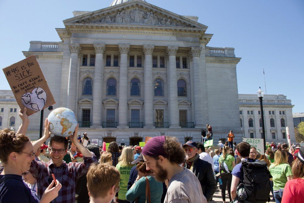  Thousands in Madison spent Earth Day marching from the state Capitol to Madison Gas and Electric, as part of an international movement to advocate for climate science and environmental protections.