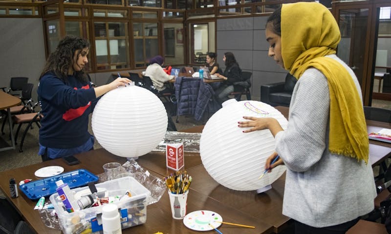 Students make lanterns in preparation for the Night Festival Wednesday at 5:30 p.m. in the Multicultural Student Center.