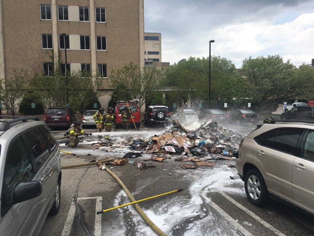 The Madison Fire Department extinguishes a pile of garbage Monday after an Advanced Disposal truck started on fire.