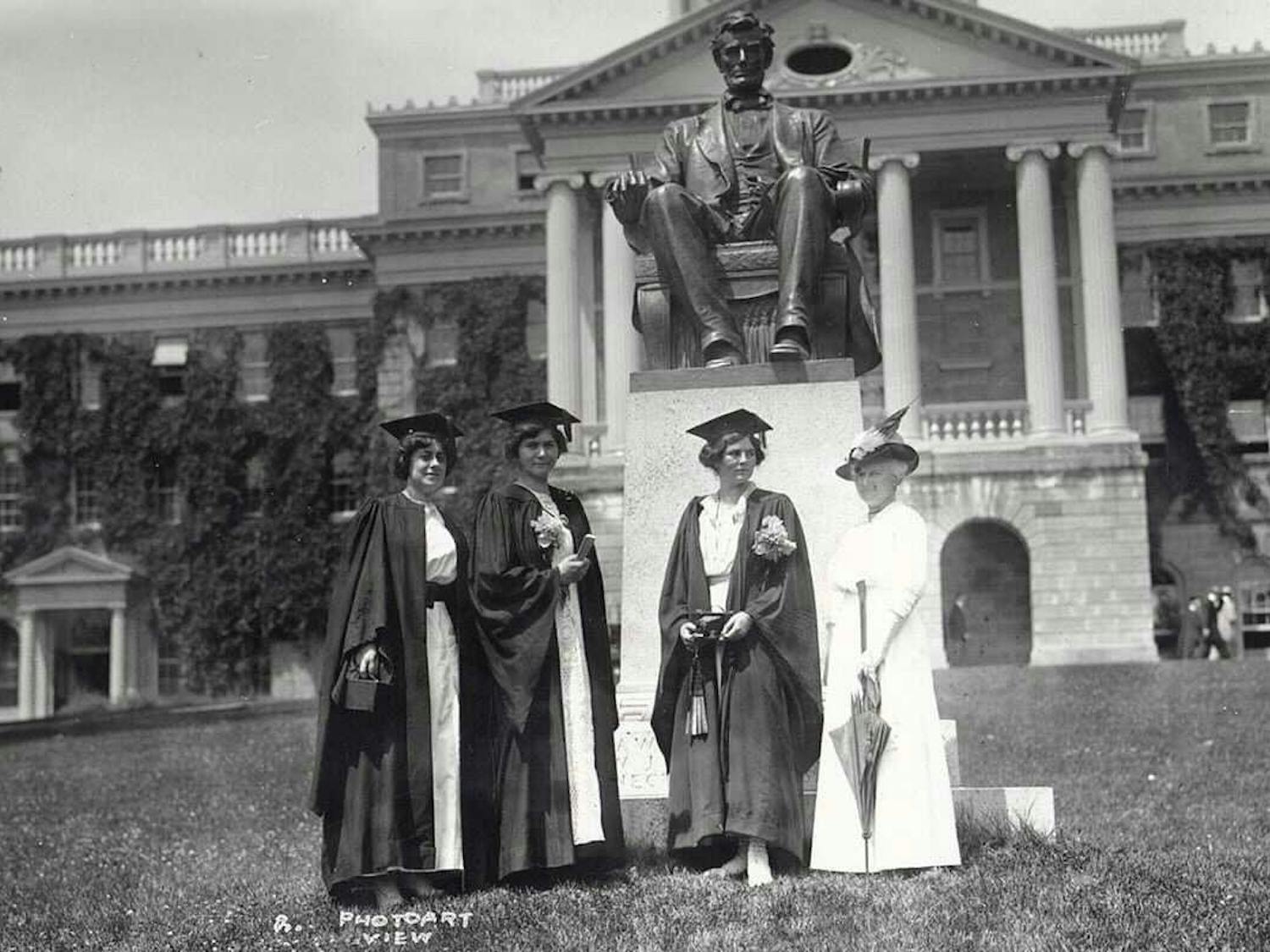 Women graduates stand in front of Bascom in a historical photo