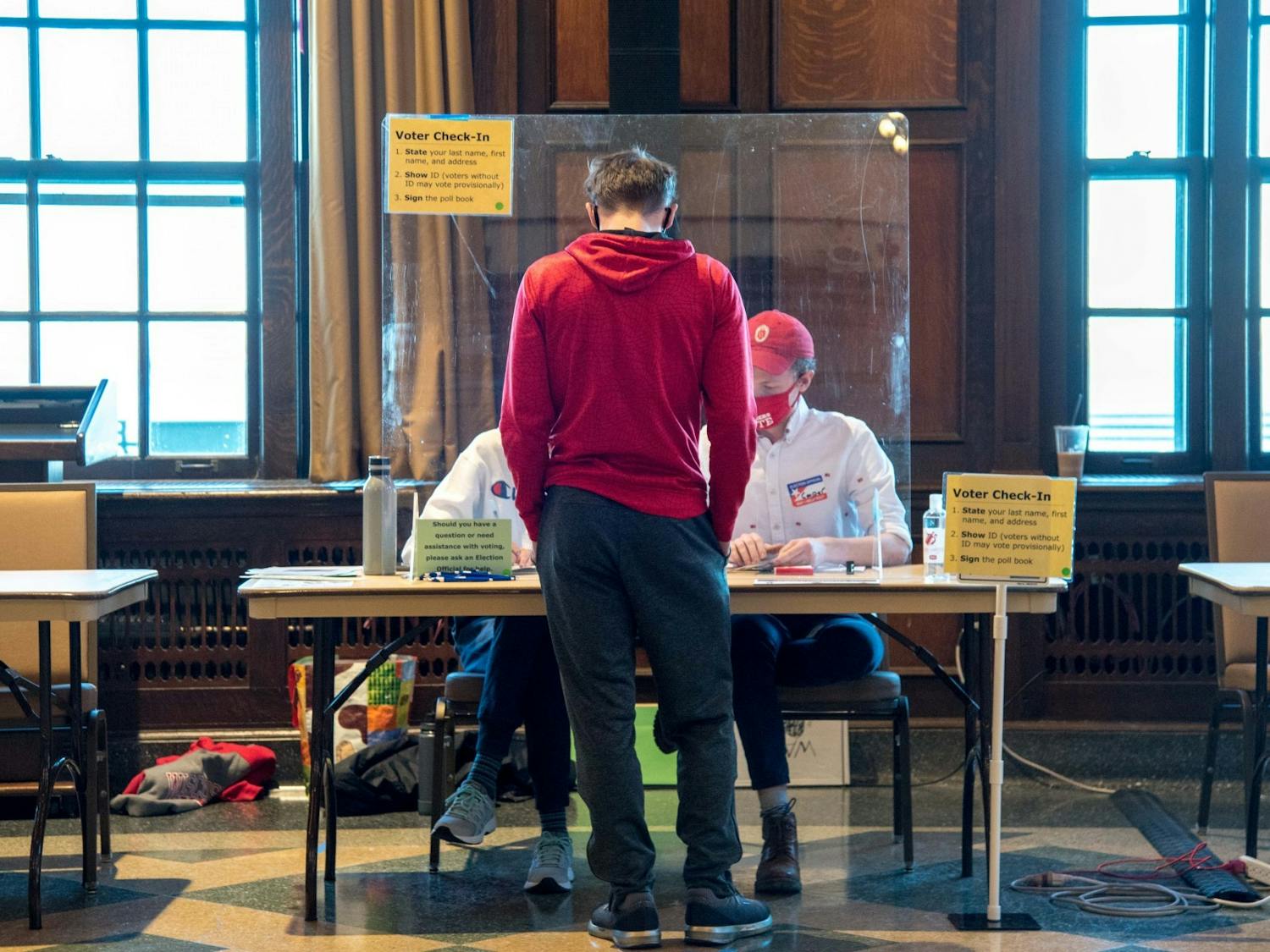 Photo of student getting a ballot to vote.