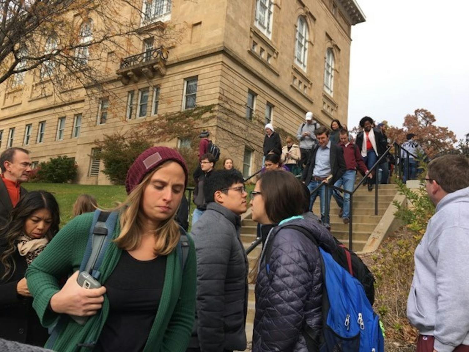 Students hurry away from Bascom after a man with a gun was reported at the Law Library.