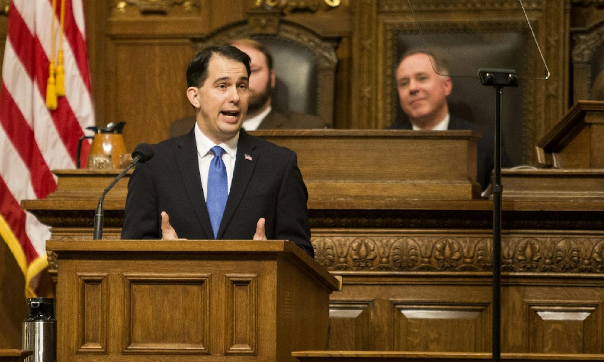 Gov. Scott Walker signed over 20 bills into law Thursday, including measures that allow hunters to wear pink and reform the foster care system.