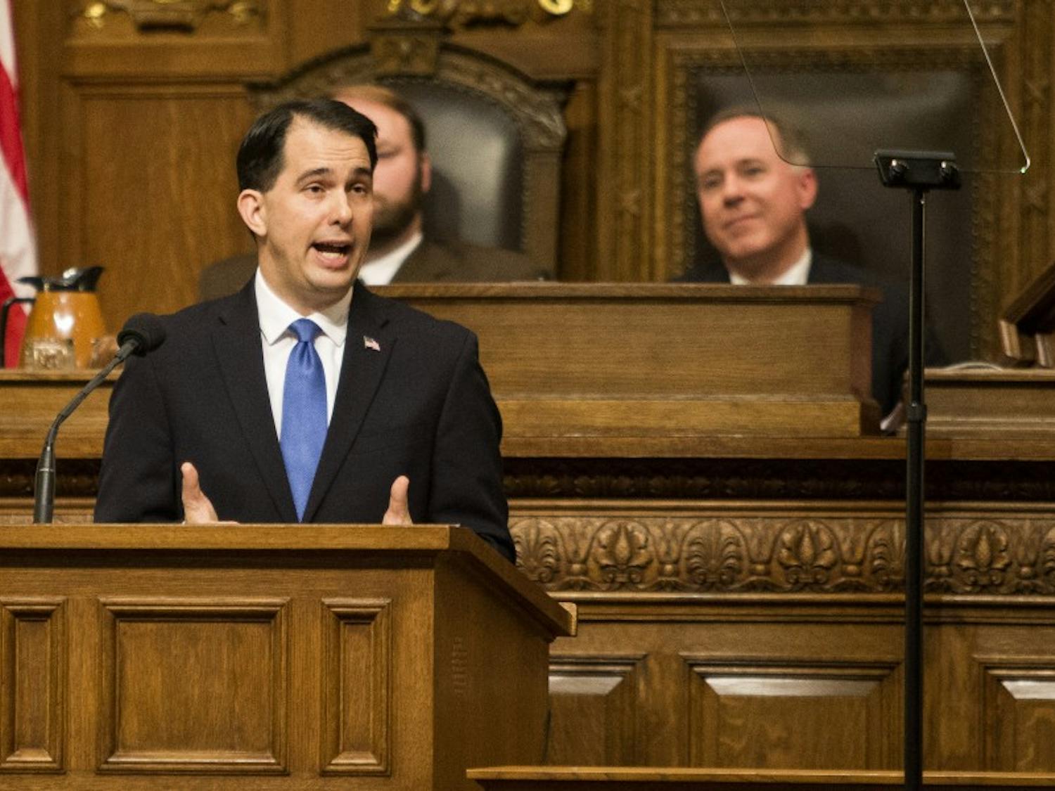 Gov. Scott Walker signed over 20 bills into law Thursday, including measures that allow hunters to wear pink and reform the foster care system.