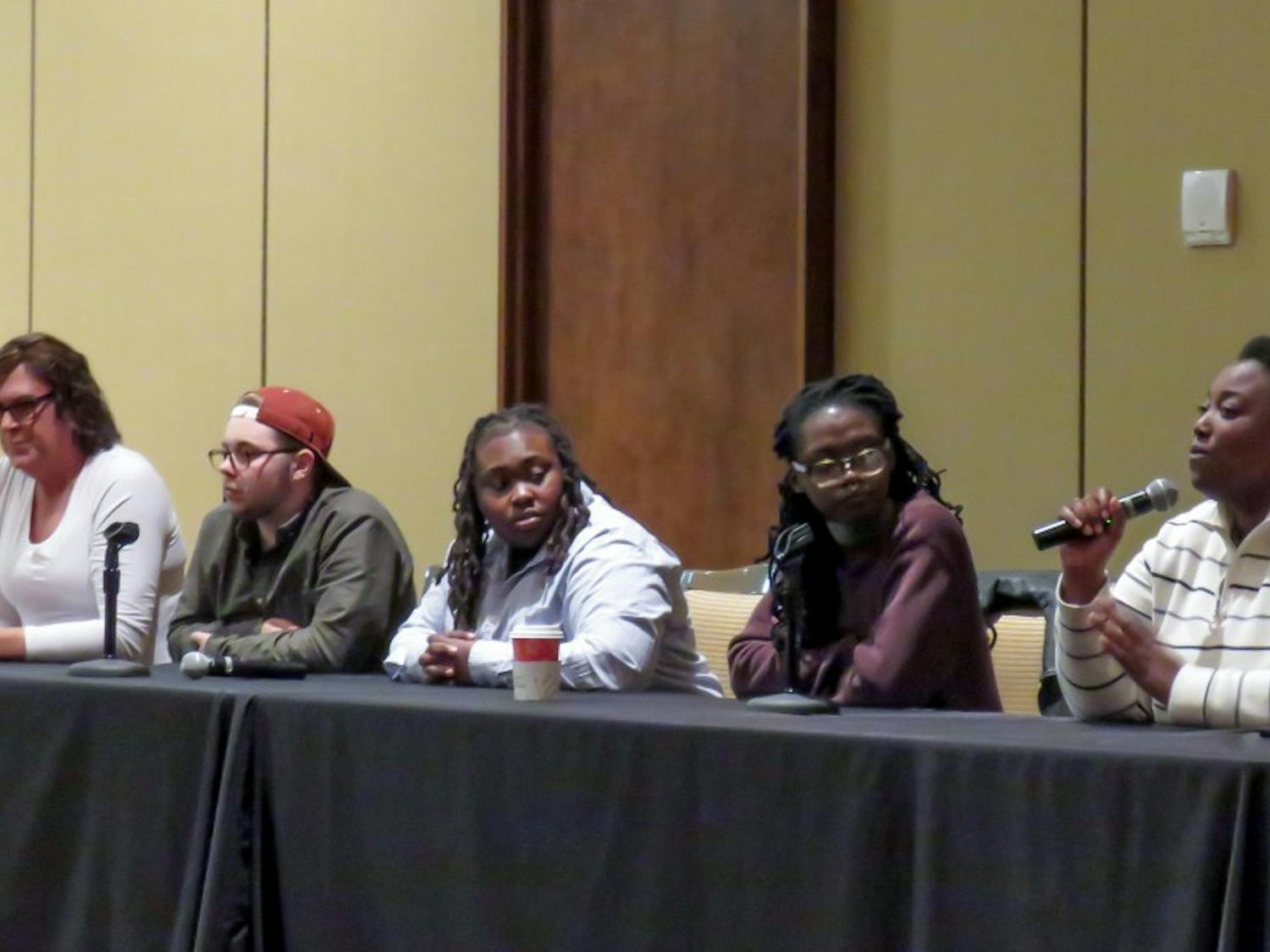 Transgender and gender non-conforming students and community members discuss their experiences on campus at a panel held at Union South Wednesday night.