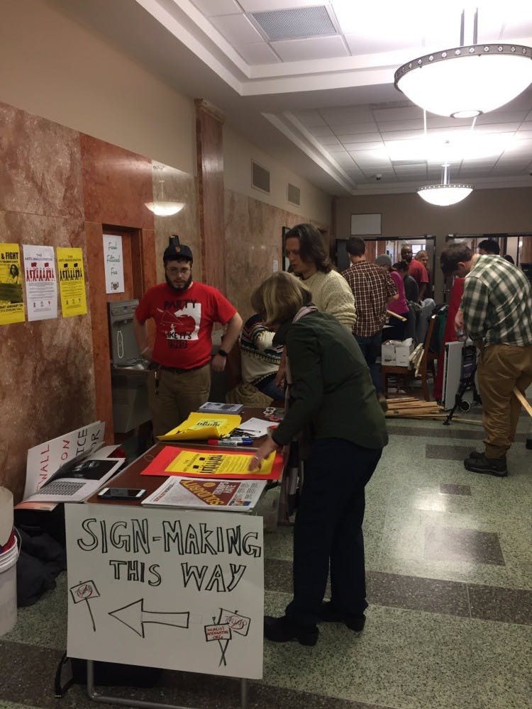 Following a student walk-out&nbsp;Friday, students and community members prepared for a city-wide march by making signs at Memorial Library.