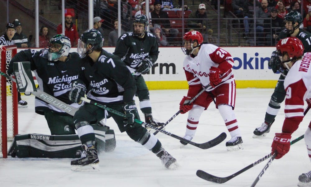 Sophomore forward Sean Dhooghe scored two goals, the second with just 26.2 seconds remaining in overtime, to give Wisconsin a needed three points in the Big Ten standings