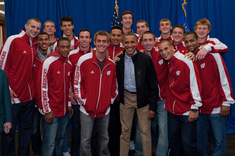 The 2012 basketball team poses for a picture with Obama before his speech on Bascom Hill.&nbsp;