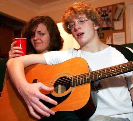 Man with acoustic guitar heralds end of house party