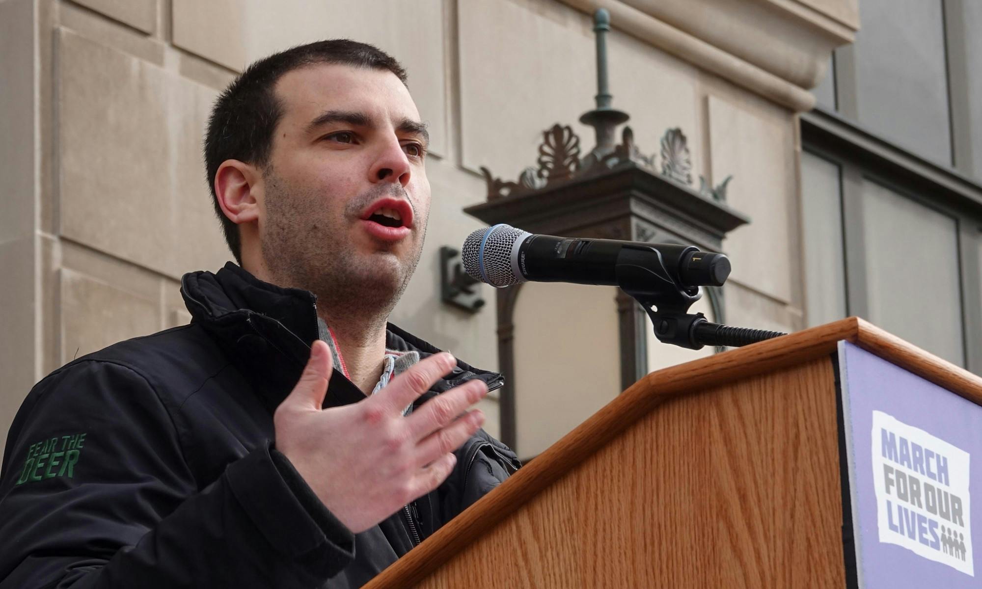 Alex Larry speaks at a rally