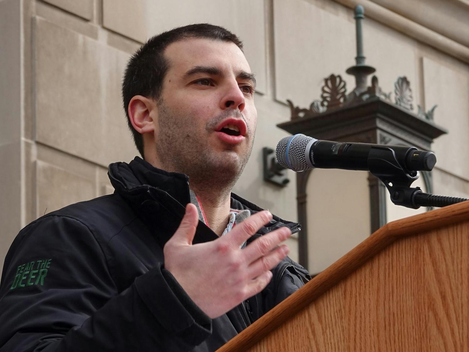 Alex Larry speaks at a rally