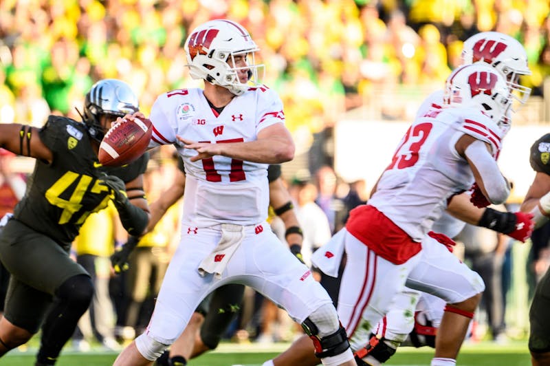 Quarterback Jack Coan looks downfield to pass the ball during the Rose Bowl game in Pasadena, California as the University of Wisconsin-Madison Badgers played the University of Oregon on Jan. 1, 2020. The Badgers lost the football game 28-27. (Photo by Bryce Richter / UW-Madison)