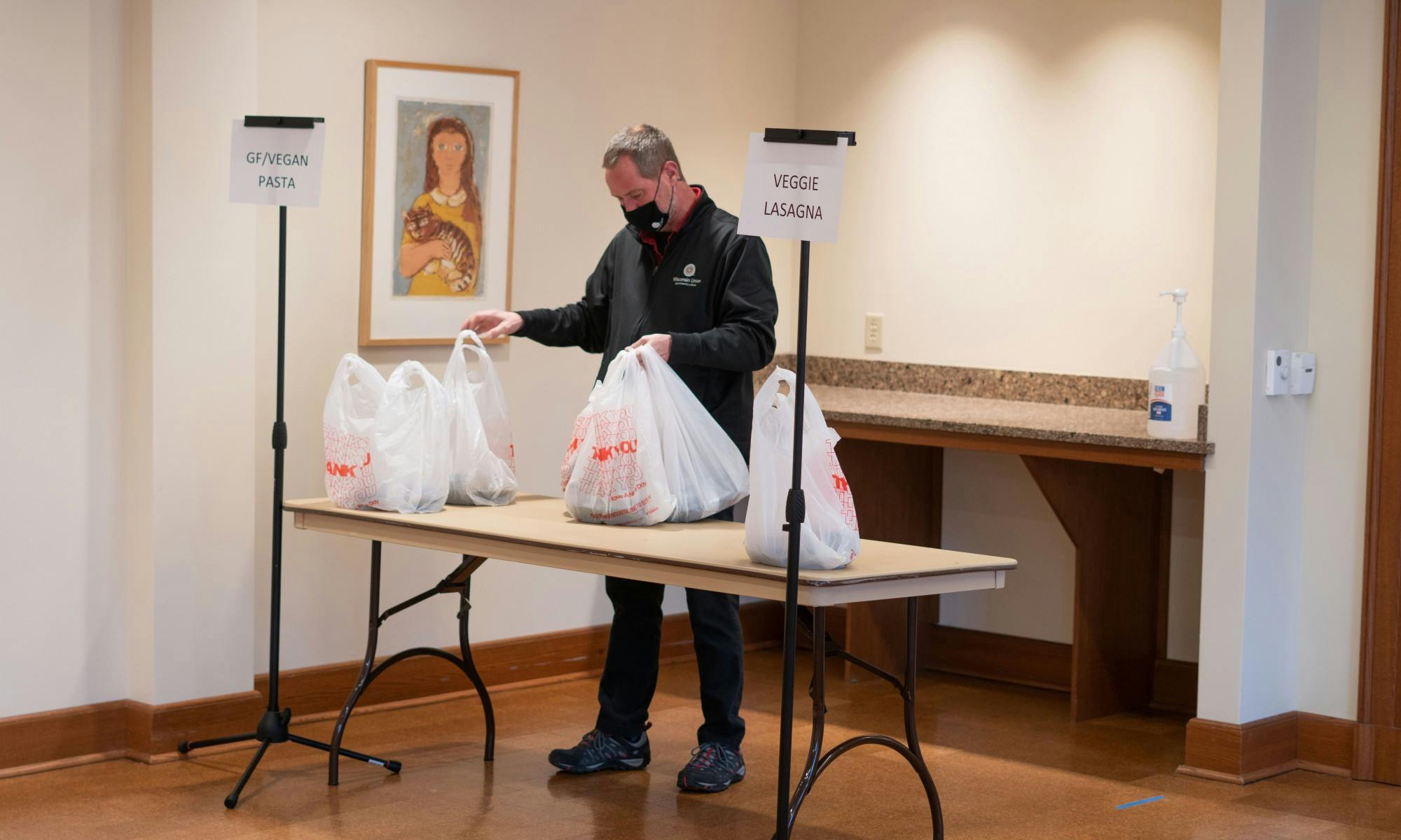 A man is bagging food for food insecure students and those who have signed up for the service at Union South.&nbsp;