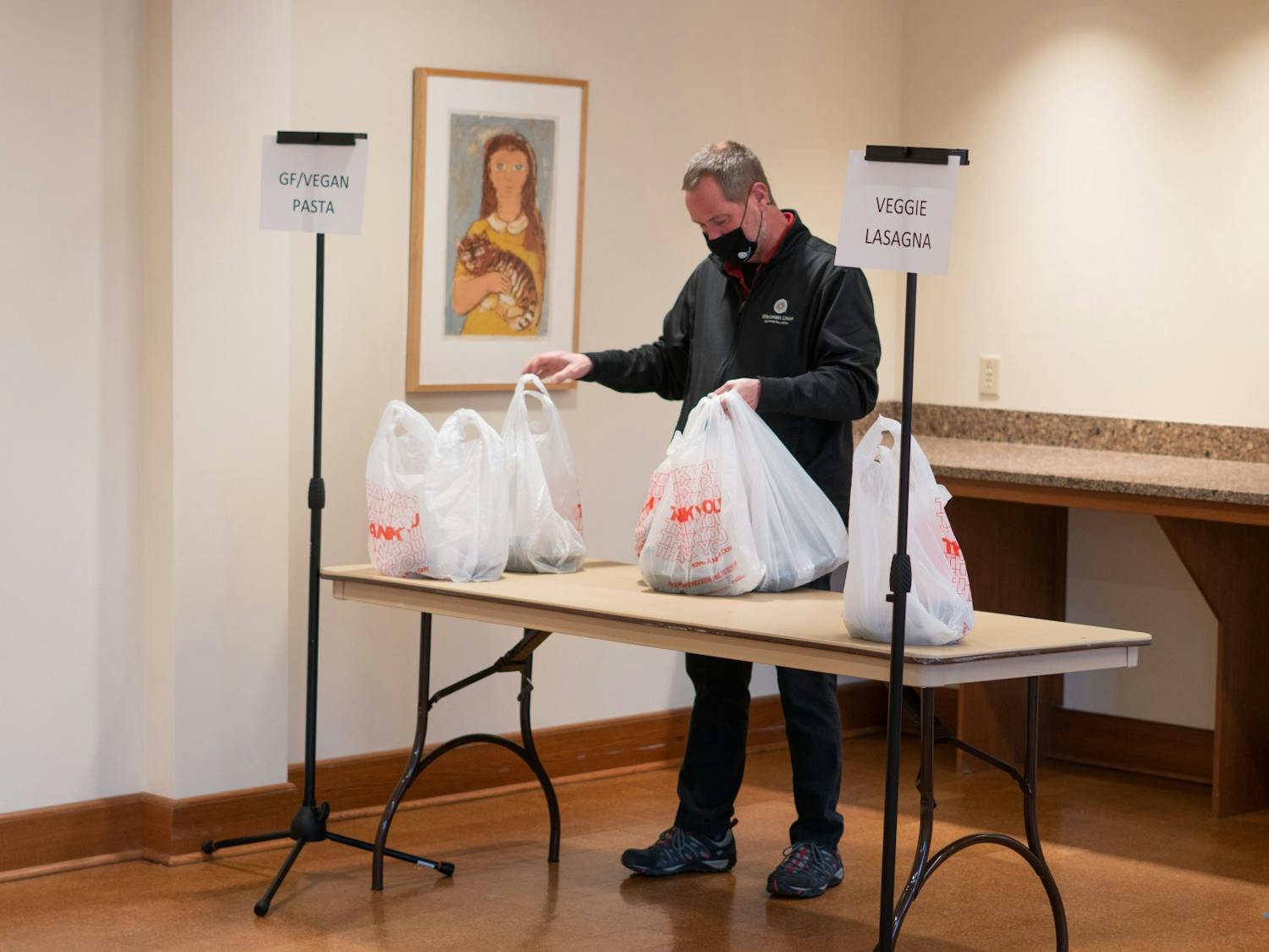 A man is bagging food for food insecure students and those who have signed up for the service at Union South.&nbsp;