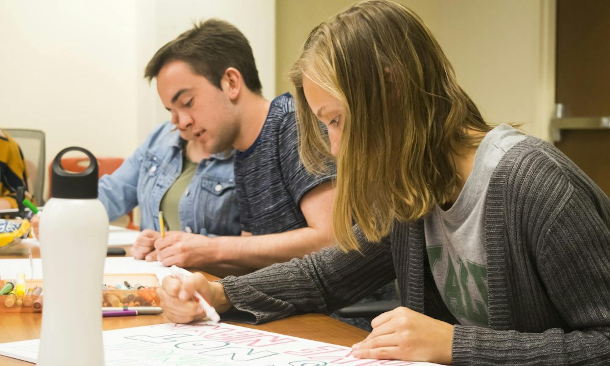 ASM Sustainability Committee Chair Billy Welsh and Vice Chair Leah Johnson made posters with other members Tuesday in preparation for the Madison Climate March this weekend.