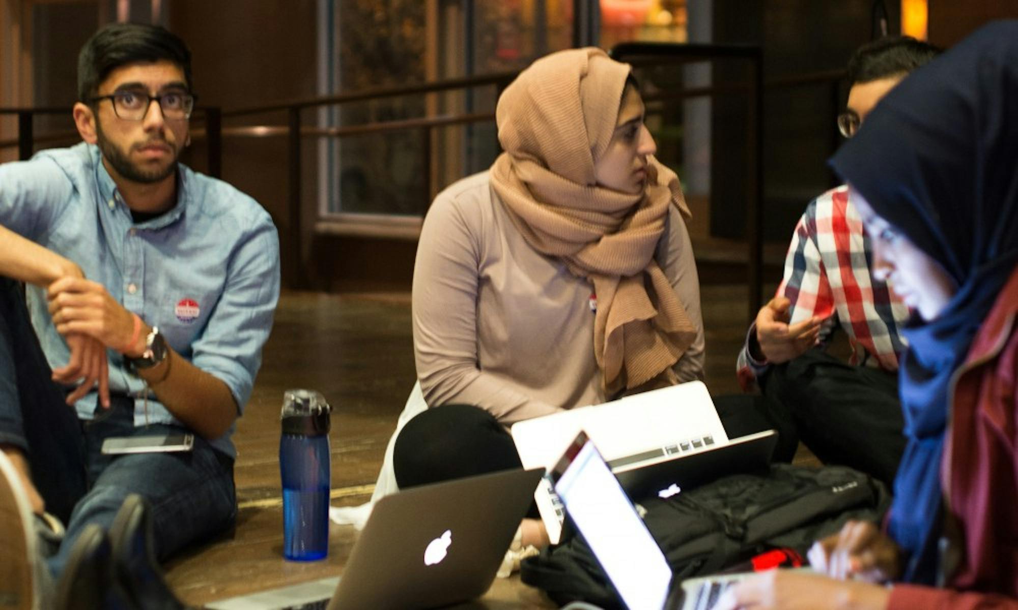 Several students, including Chair of the Shared Governance Committee Omer Arain, watch as election results pour in with Donald Trump leading.