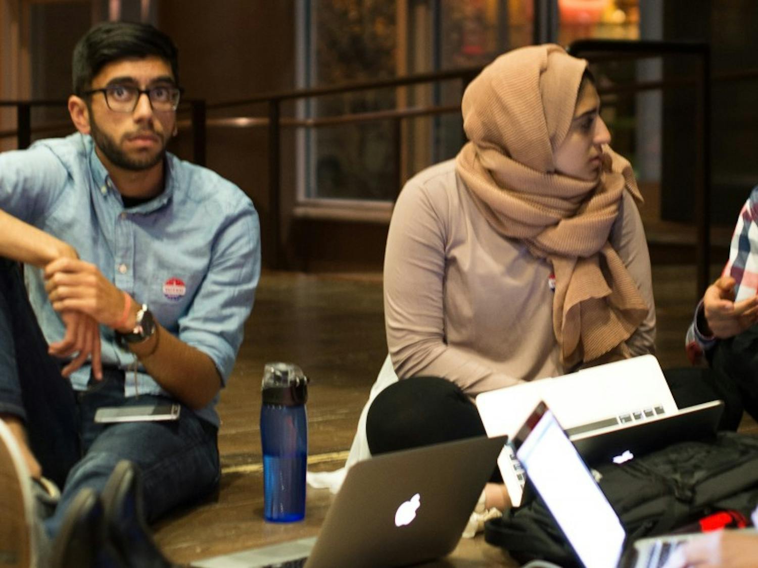 Several students, including Chair of the Shared Governance Committee Omer Arain, watch as election results pour in with Donald Trump leading.