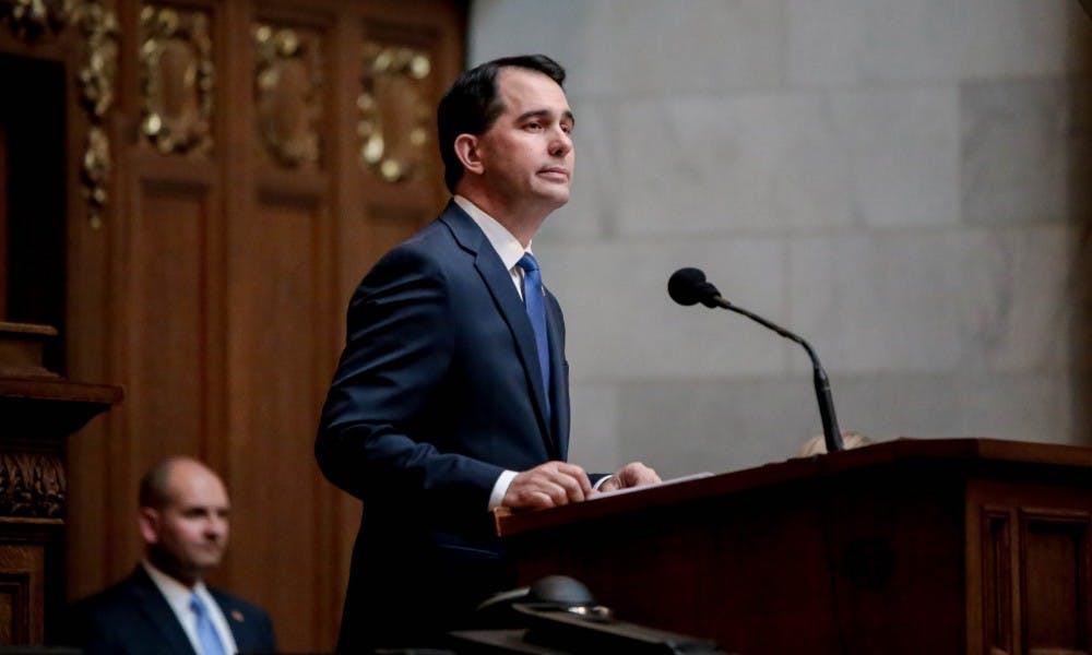As Scott Walker was honored for his executive orders on government transparency, an open records advocacy group debated his record on the matter.