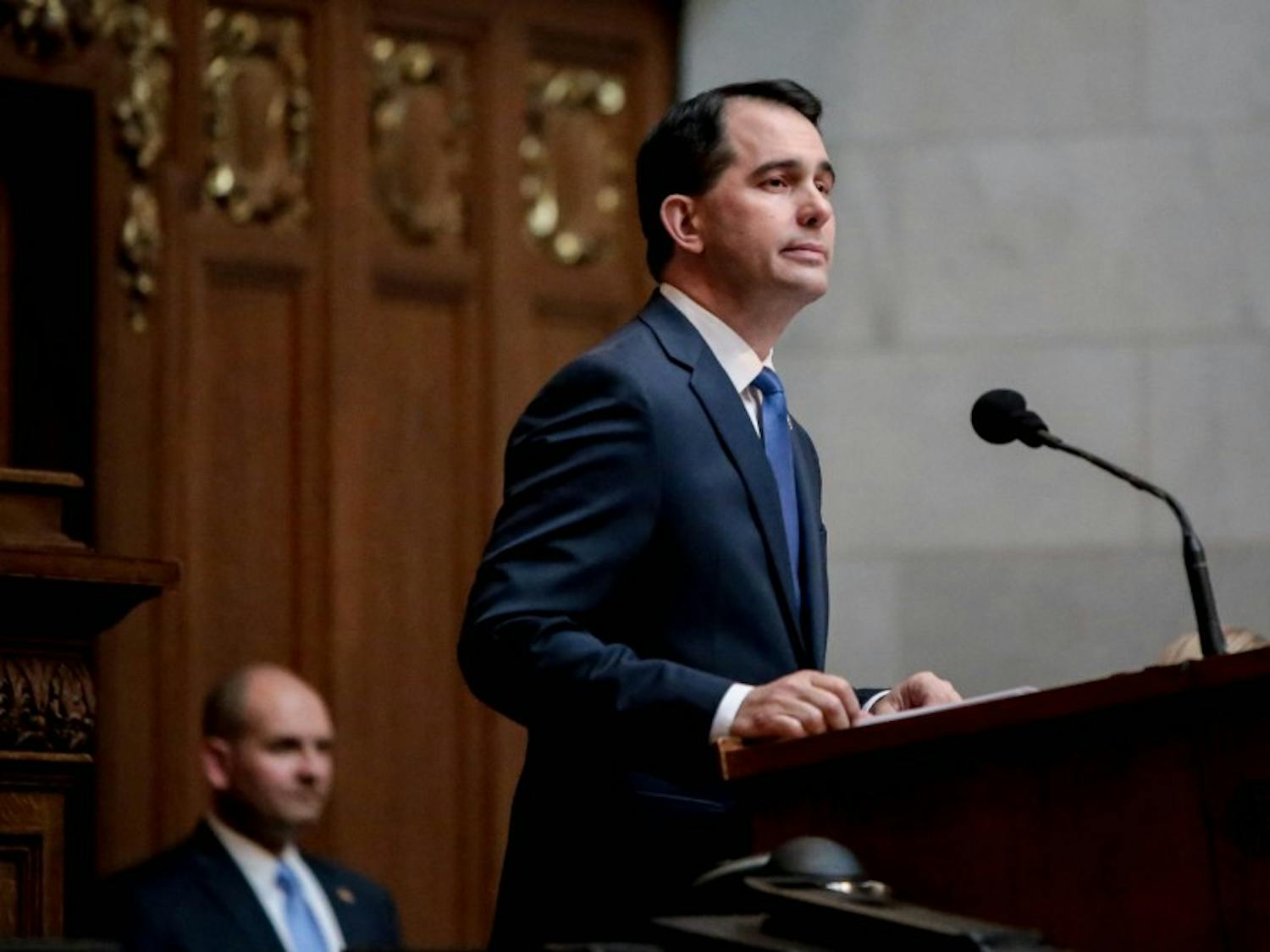 As Scott Walker was honored for his executive orders on government transparency, an open records advocacy group debated his record on the matter.