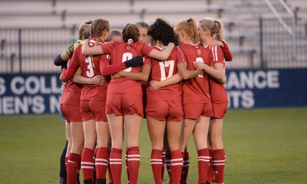 Photo of the Badger soccer team in a huddle.