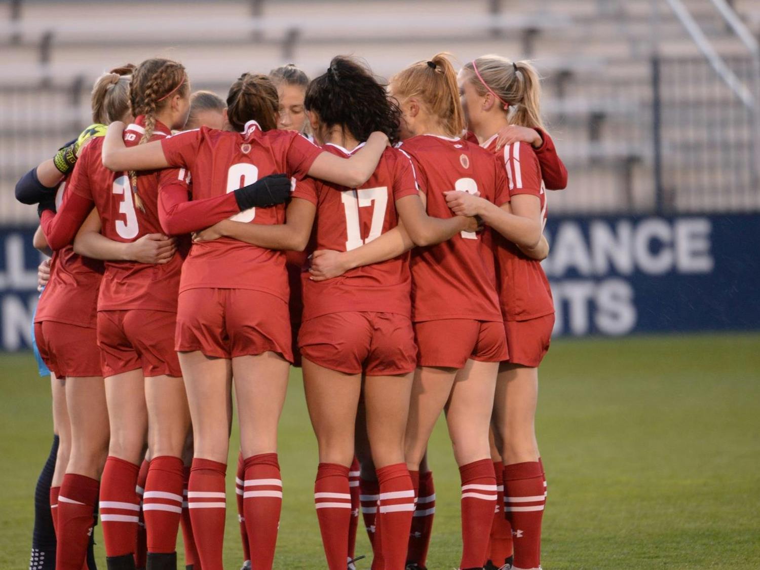 Photo of the Badger soccer team in a huddle.